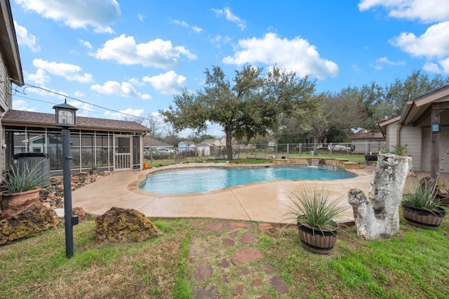 view of swimming pool with a patio area, a sunroom, and pool water feature