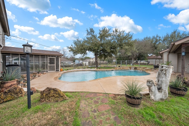 view of swimming pool featuring a sunroom, a patio area, fence, and a fenced in pool