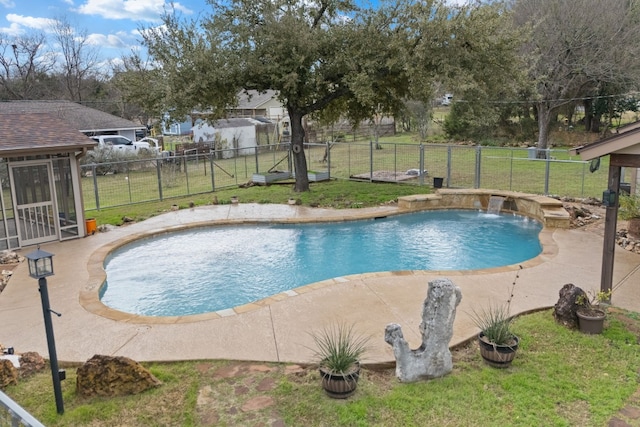 view of swimming pool featuring pool water feature, a patio area, and a lawn