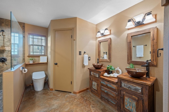 bathroom featuring vanity, toilet, and a tile shower