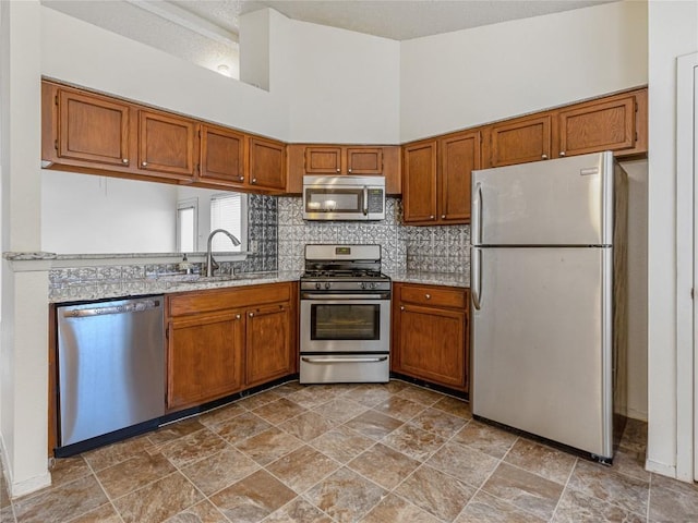 kitchen featuring sink, stainless steel appliances, and a high ceiling