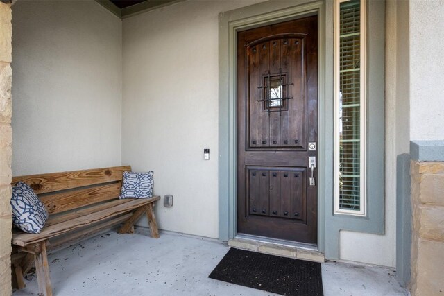 doorway to property with stucco siding