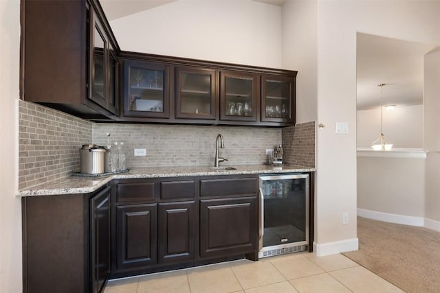 2715 Mariposa Way, Round Rock, TX 78665 - indoor wet bar with wine cooler, backsplash, light tile patterned flooring, light colored carpet, and lofted ceiling