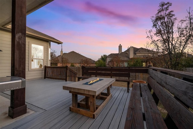 deck at dusk with an outdoor fire pit