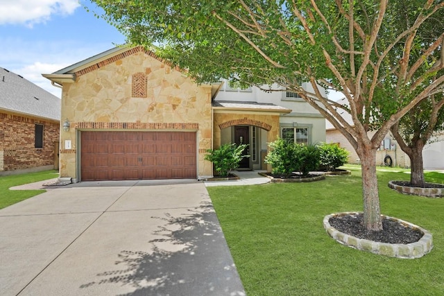 2715 Mariposa Way, Round Rock, TX 78665 - view of front facade featuring concrete driveway, stone siding, a front yard, and an attached garage