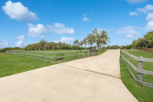 view of community featuring a yard and a rural view