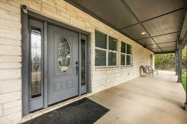 view of exterior entry with covered porch