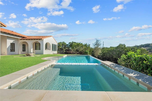 view of pool featuring an in ground hot tub and a lawn