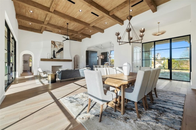 dining area with beam ceiling, a wealth of natural light, wooden ceiling, and wood-type flooring