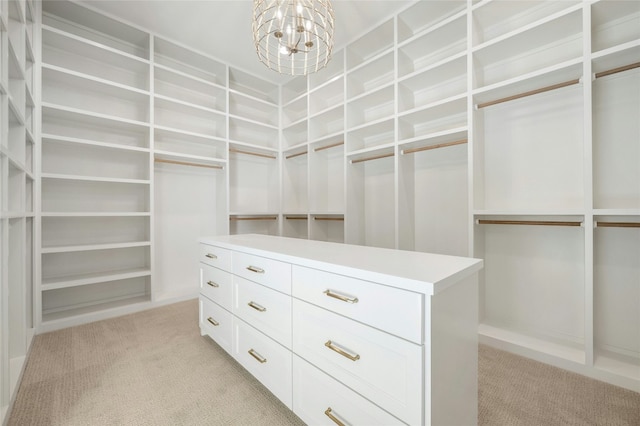 spacious closet featuring a notable chandelier and light carpet