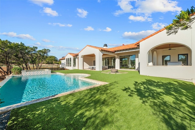 back of house with a yard, ceiling fan, and a patio area