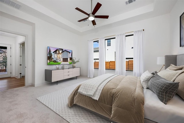 7501 Becasseau Dr, Austin, TX 78738 - carpeted bedroom with a raised ceiling and a ceiling fan