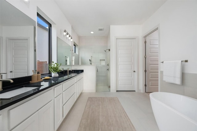 7501 Becasseau Dr, Austin, TX 78738 - full bath with a shower stall, double vanity, and a freestanding tub