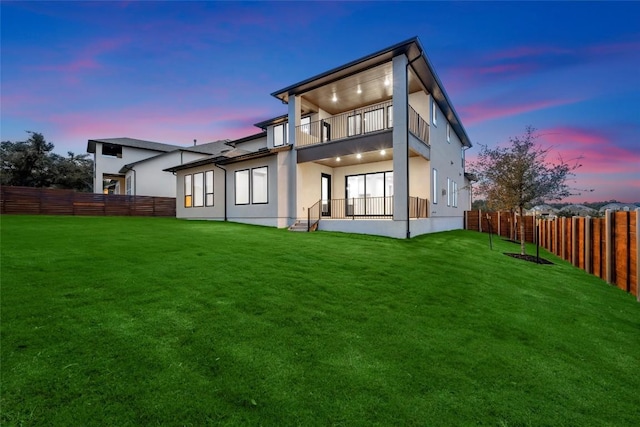 7501 Becasseau Dr, Austin, TX 78738 - rear view of house featuring a balcony, a fenced backyard, and stucco siding