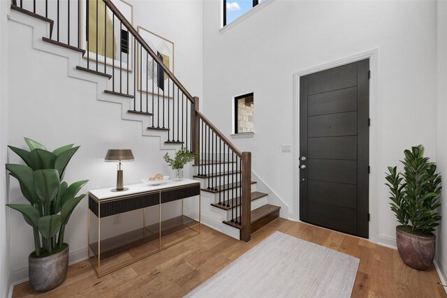 7501 Becasseau Dr, Austin, TX 78738 - entrance foyer with stairs, wood finished floors, and a high ceiling