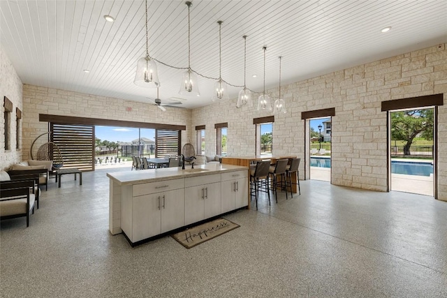 7501 Becasseau Dr, Austin, TX 78738 - kitchen featuring open floor plan, a ceiling fan, healthy amount of natural light, and hanging light fixtures