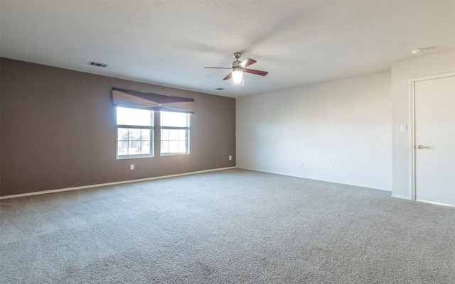 empty room featuring carpet floors and ceiling fan