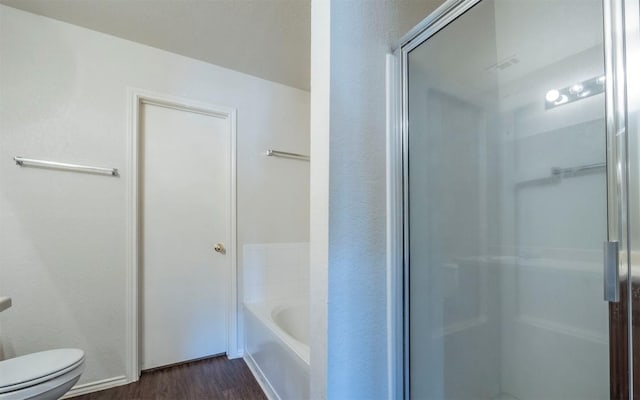 bathroom featuring plus walk in shower, wood-type flooring, and toilet