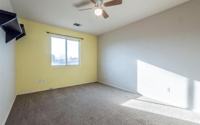 spare room featuring carpet and ceiling fan