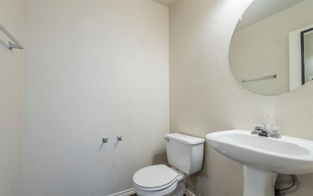 bathroom featuring toilet and sink