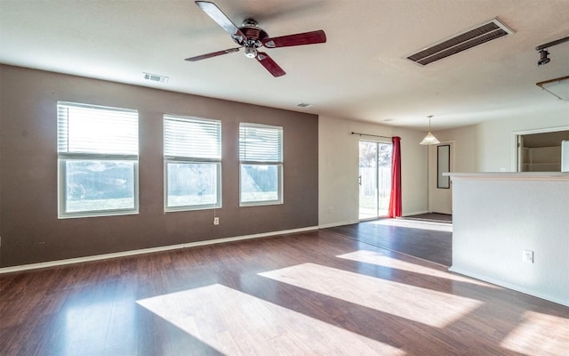 spare room featuring ceiling fan and dark hardwood / wood-style flooring