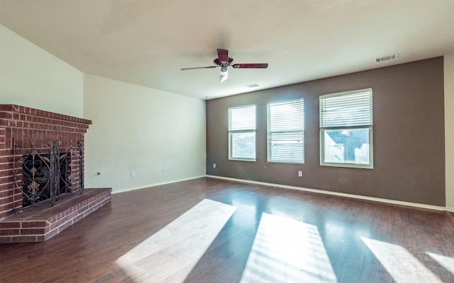 unfurnished living room featuring ceiling fan, dark hardwood / wood-style flooring, and a fireplace