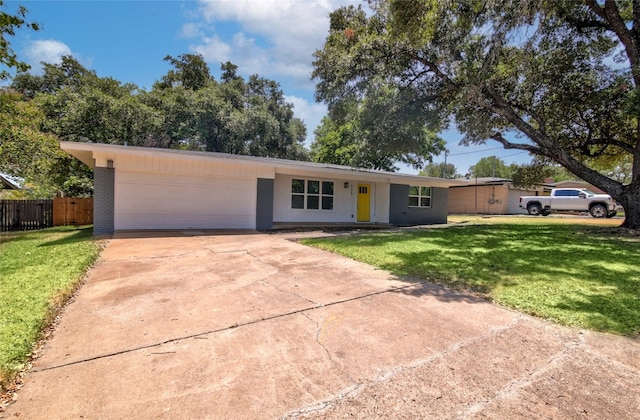 single story home featuring a front yard and a garage