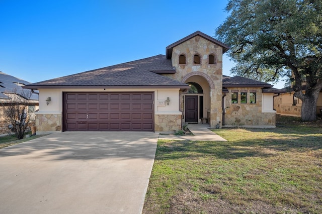 view of front of home with a garage and a front lawn