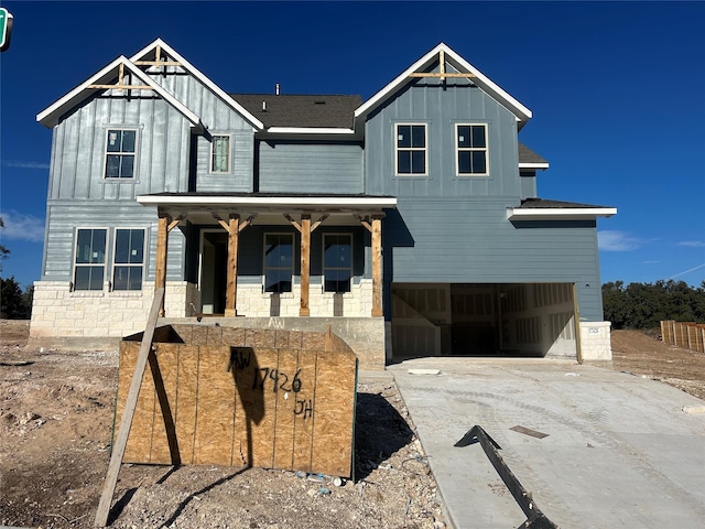 view of front of property featuring a porch and a garage