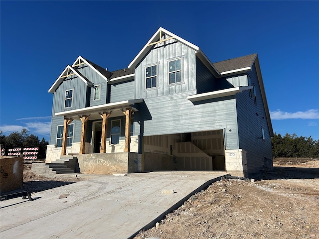 view of front of house featuring a porch and a garage