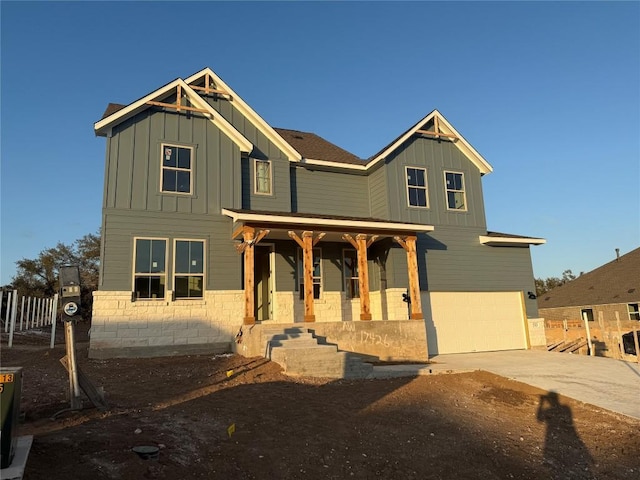 craftsman-style house featuring a porch and a garage