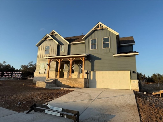 craftsman inspired home with a garage and a porch