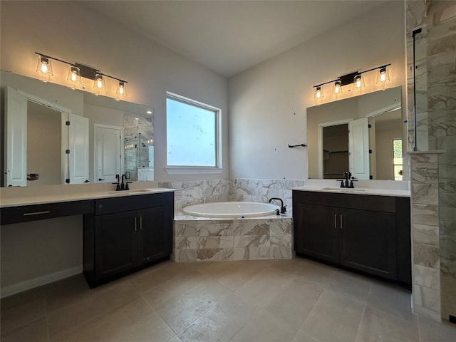 bathroom featuring a garden tub, two vanities, a sink, and a shower stall