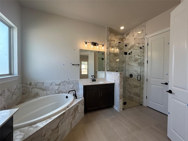 bathroom with a stall shower, tile patterned floors, a bath, and vanity