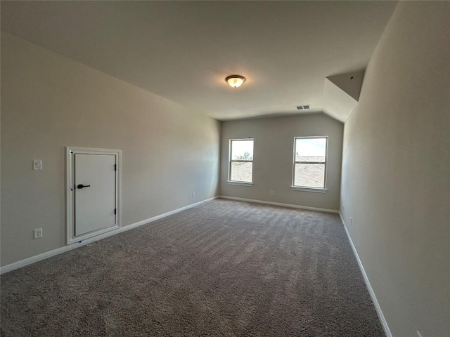 bonus room featuring lofted ceiling, carpet flooring, visible vents, and baseboards