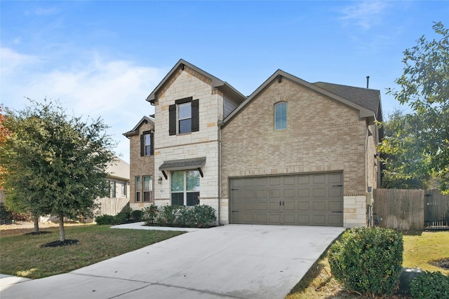 view of front of house featuring a garage and a front lawn