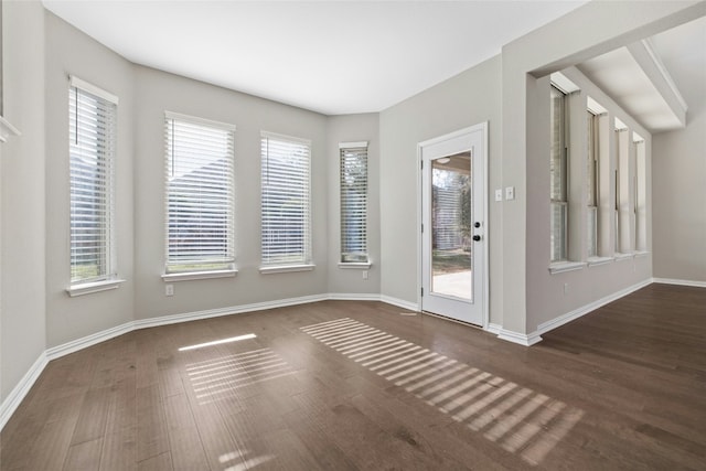 unfurnished room featuring dark wood-type flooring