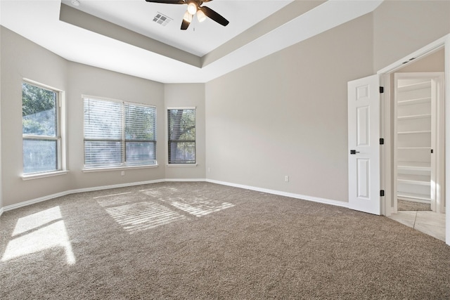 unfurnished room with light carpet, plenty of natural light, and ceiling fan