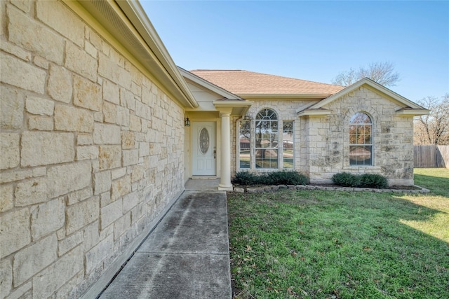 entrance to property featuring a lawn