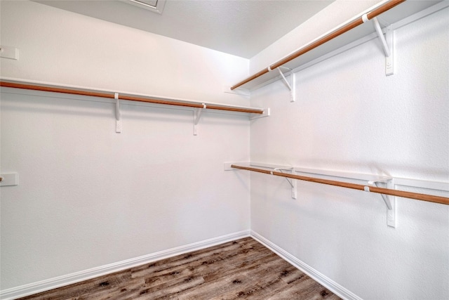 walk in closet with hardwood / wood-style floors