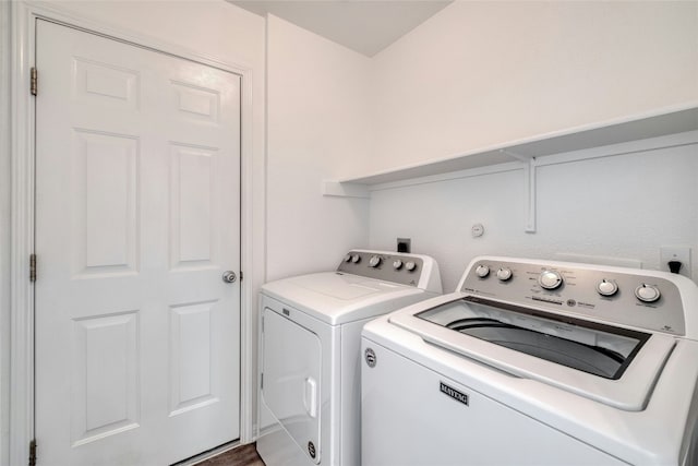 clothes washing area with hardwood / wood-style flooring and washer and clothes dryer