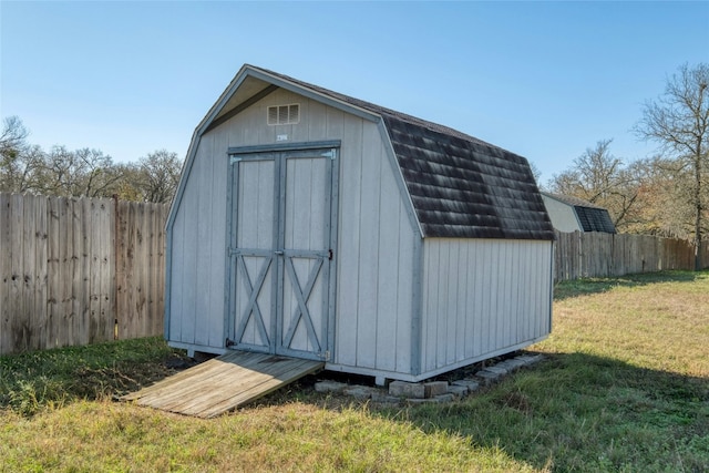 view of outbuilding with a lawn