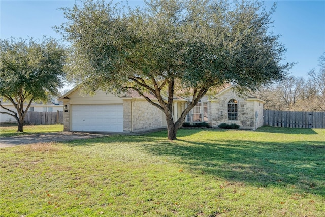 view of front of home featuring a front yard and a garage