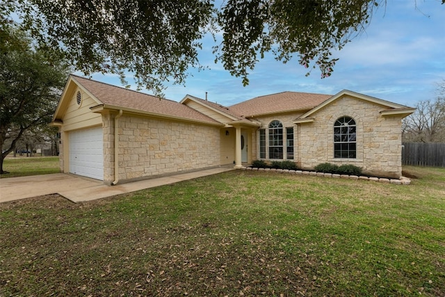 ranch-style house featuring a garage and a front lawn