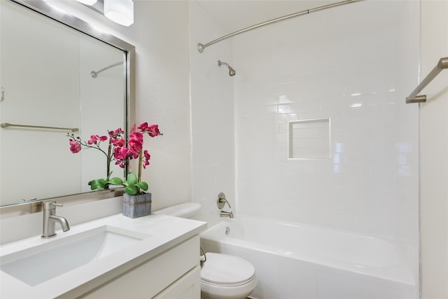 full bathroom with vanity, tiled shower / bath combo, and toilet