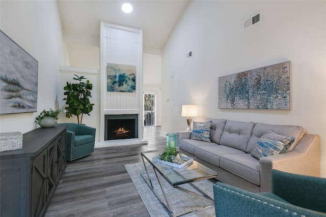 living room featuring dark hardwood / wood-style floors and a high ceiling