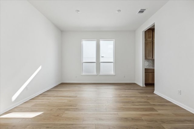 spare room with light hardwood / wood-style flooring