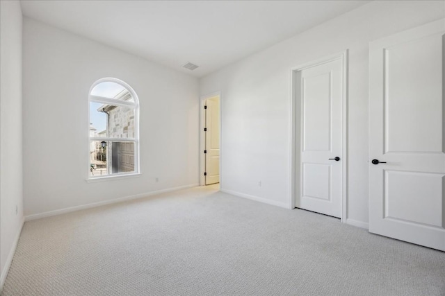 unfurnished bedroom featuring light colored carpet