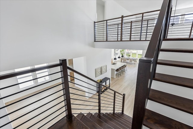 stairs featuring hardwood / wood-style floors