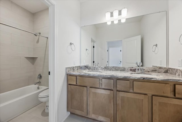 full bathroom with toilet, tile patterned flooring, vanity, and tiled shower / bath